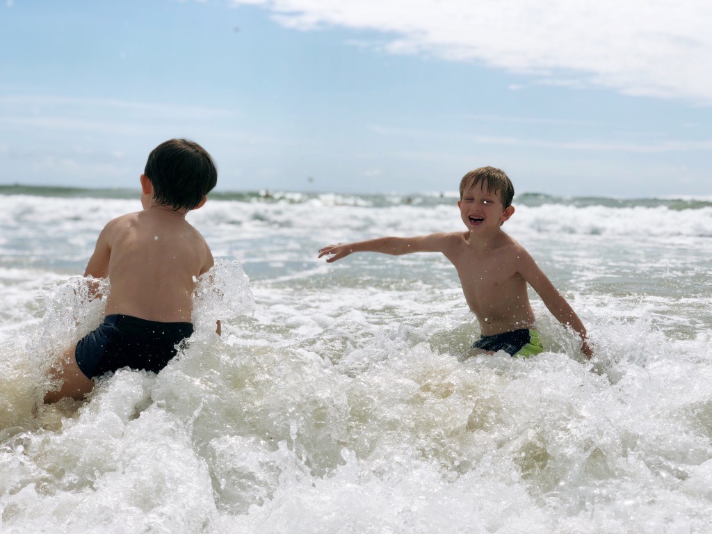 finding your flow at the beach / boy playing joyfully at the beach