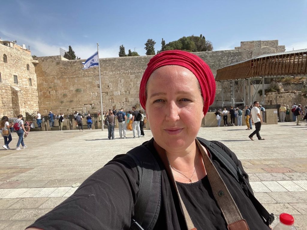 Woman standing in from the holy Jewish Western Wall in Jerusalem, Israel.